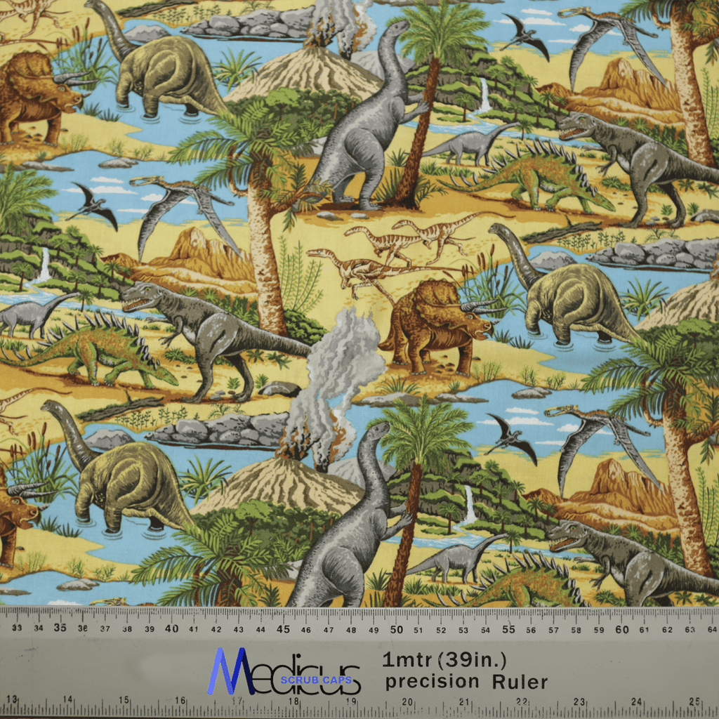 The Dinosaurs Lost In Time #1 Scrub Cap by Medicus Scrub Caps features a vibrant design with dinosaurs, volcanoes, and prehistoric landscapes. Includes ruler for scale.
