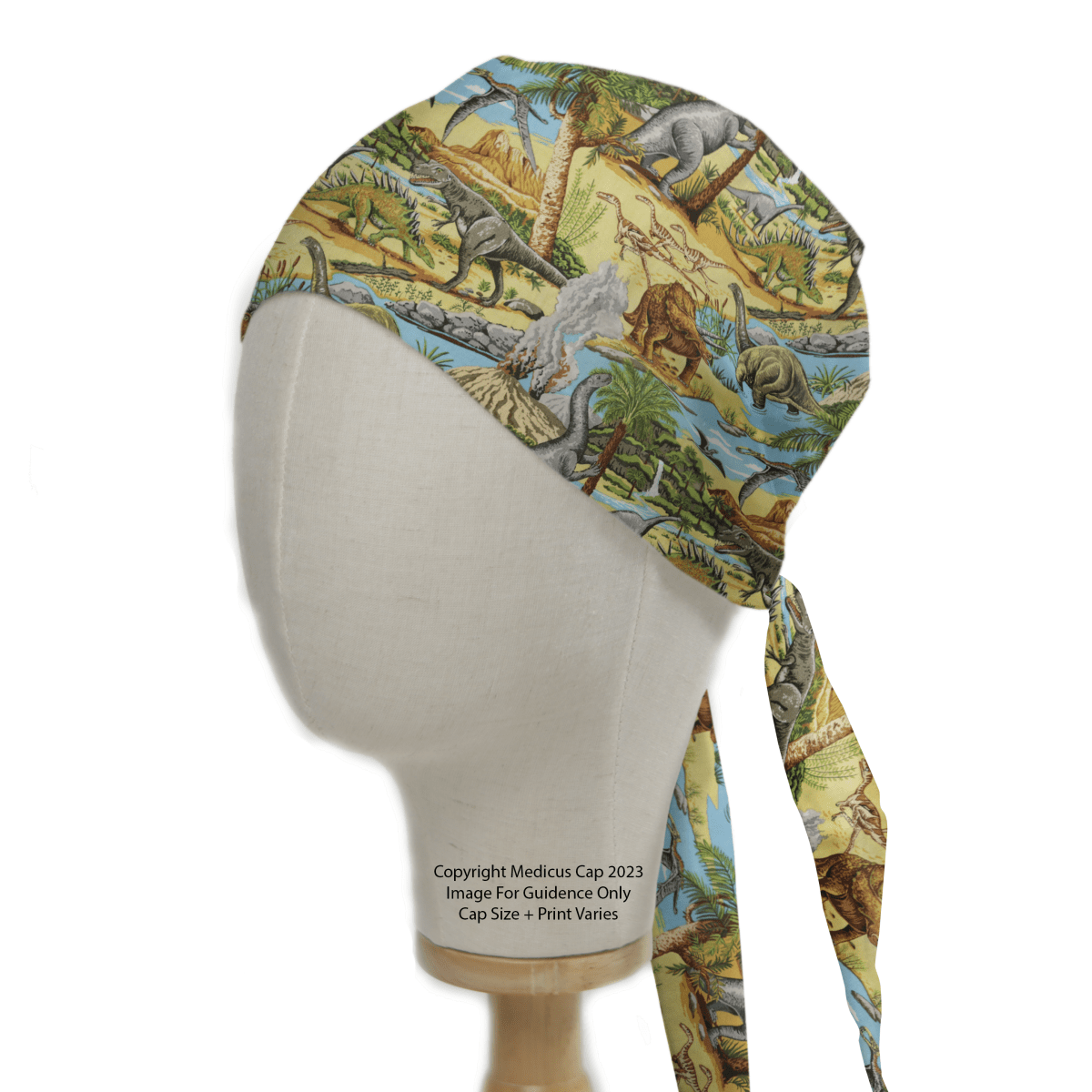 Displayed on a mannequin, the Medicus Scrub Caps’ Dinosaurs Lost In Time #1 features a vibrant dinosaur-themed print with trees and landscapes. Viewed from the side, its detailed design and tied back make it a unique healthcare accessory.
