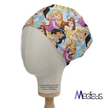 A mannequin head displays a vibrant Disney Princesses Gang Scrub Cap by Medicus Scrub Caps, featuring cartoon princesses on a light blue background. The reusable design ensures longevity, with the Medicus Scrub Caps logo on the bottom right corner.
