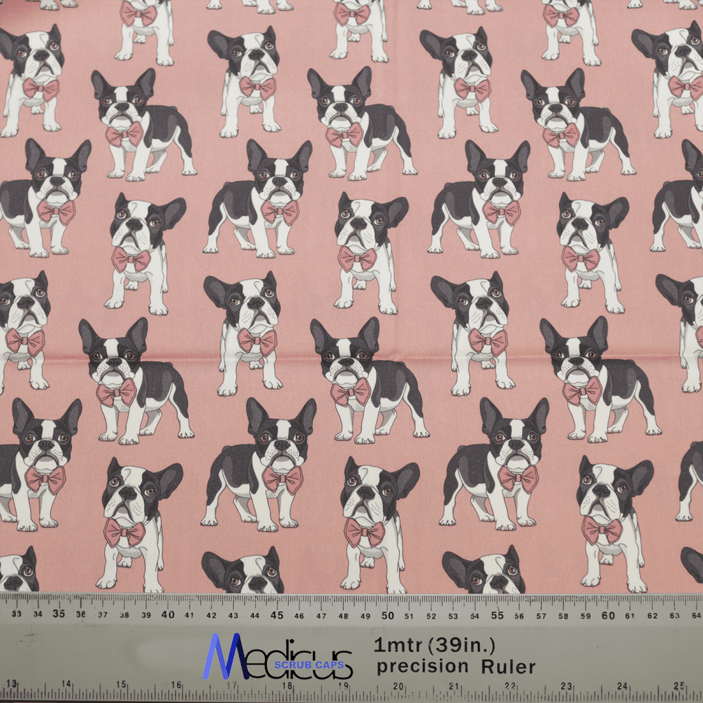 The Dog Breeds French Bulldog Salmon Pink Scrub Cap from Medicus Scrub Caps features rows of black and white French bulldogs with pink bows on a pink backdrop, ideal for eco-friendly scrub caps. A ruler in the image shows approximately 1 meter of this charming design.