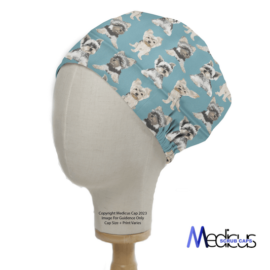 A mannequin head displays a Dog Breeds Yorkshire Terrier (Yorkie) Blue Scrub Cap, featuring an elastic back section and the Medicus Scrub Caps label at the bottom right.