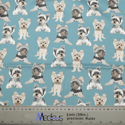 Patterned teal fabric features small Yorkshire Terriers in various poses, with a ruler for measurements in inches and centimeters, plus Medcare text. Ideal for creating an eco-friendly Dog Breeds Yorkshire Terrier (Yorkie) Blue Scrub Cap or adding personalized embroidery touches. Brand: Medicus Scrub Caps.