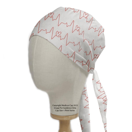 The Medicus Scrub Caps EKG Heart Monitor #1 White Scrub Cap features red EKG and heart patterns on white fabric, displayed on a mannequin head.