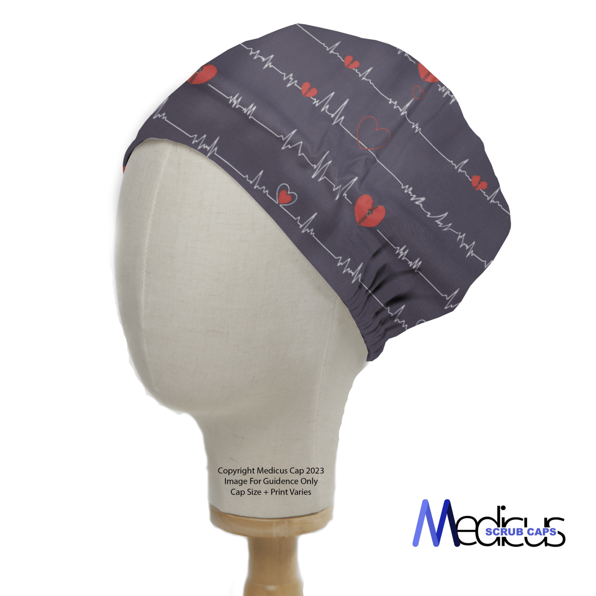 A mannequin head displays the EKG Heart Monitor #2 Scrub Cap from Medicus Scrub Caps, featuring red hearts and ECG line patterns with the logo in the lower right corner, emphasizing its medical theme.