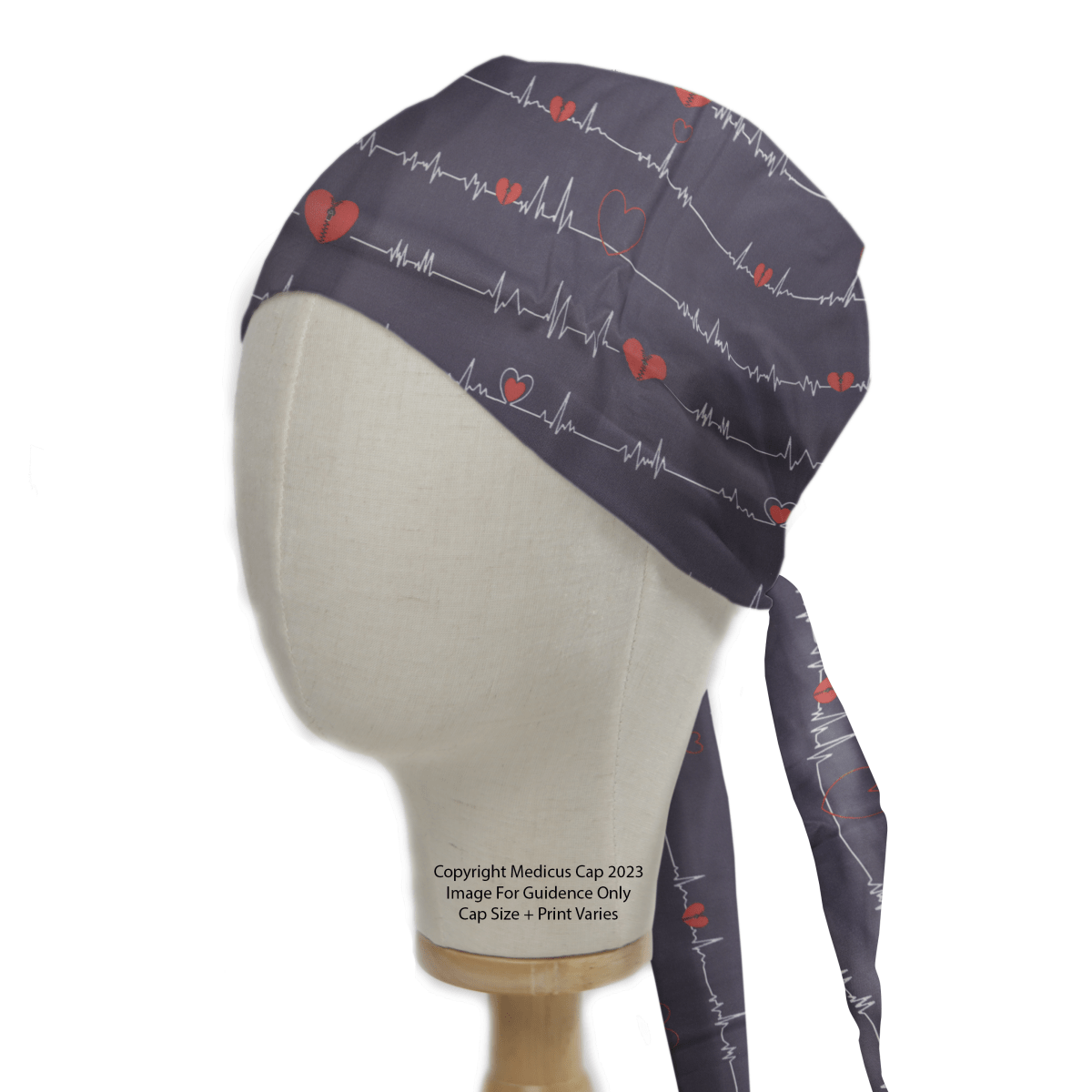 The Medicus Scrub Caps EKG Heart Monitor #2 showcases an eco-friendly tie-back scrub cap featuring red hearts and white ECG lines, displayed on a mannequin head.