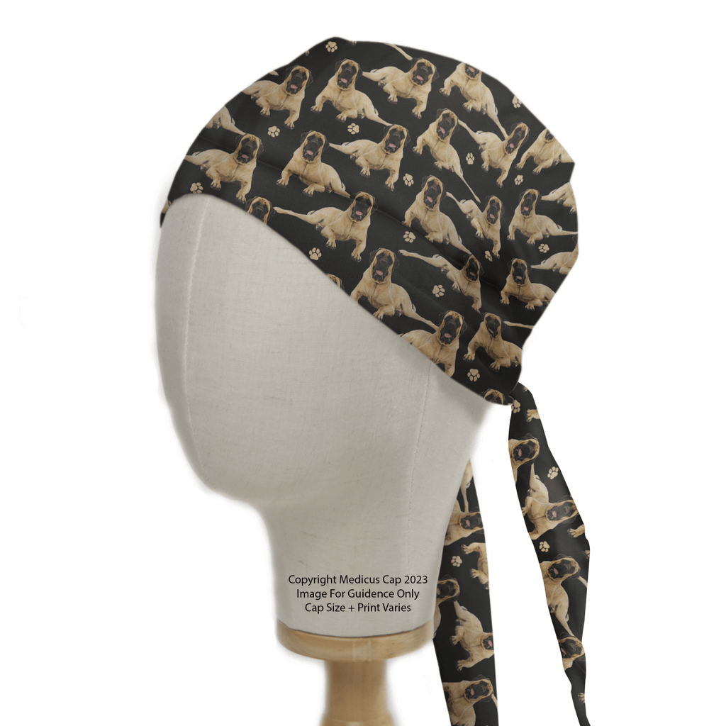 The English Bull Mastiff Dogs Black Scrub Cap from Medicus Scrub Caps features tan dogs and paw prints on black, with long ties at the back. Note: Copyright Medicus Cap 2023 Image For Guidance Only Cap Size + Print Varies. Ideal for adding a playful touch to your healthcare routine.