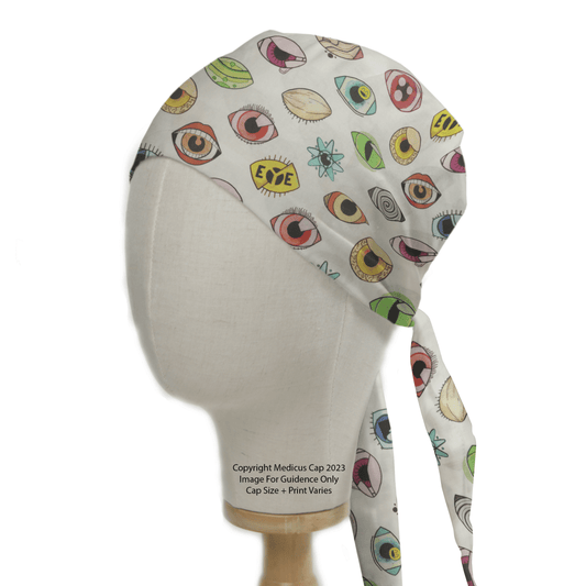 A mannequin head wears the Eyes Abstract Scrub Cap by Medicus Scrub Caps, featuring a playful design with cartoon-like eyes and stars in various shapes and colors on a white background, adding whimsical charm to healthcare attire.