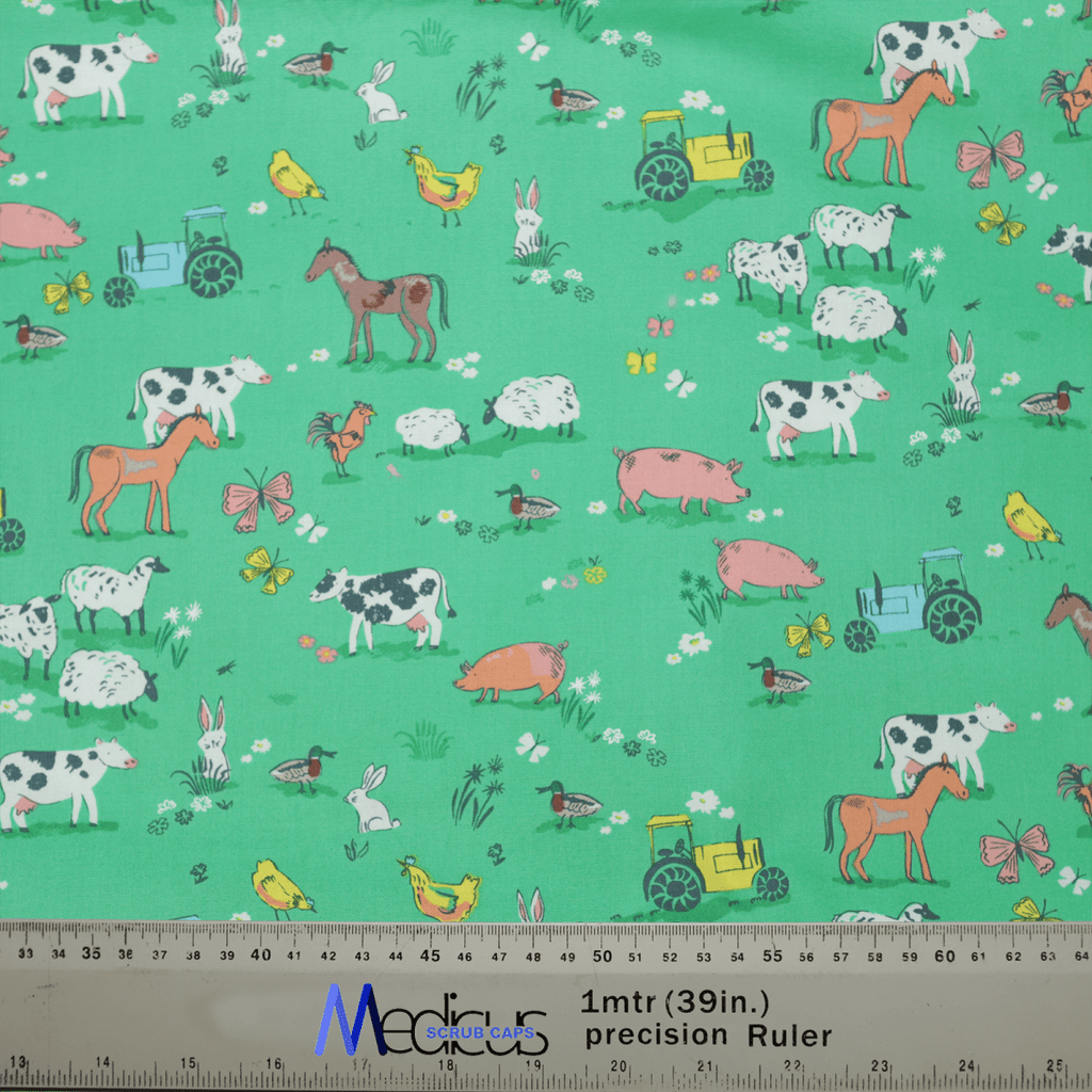 Experience tranquility with the Farmers Field Scrub Cap by Medicus Scrub Caps, made from green fabric featuring farm animals and vehicles like cows, horses, sheep, pigs, rabbits, and more. Measurements in centimeters and inches are included at the bottom for extra comfort.