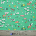 Experience tranquility with the Farmers Field Scrub Cap by Medicus Scrub Caps, made from green fabric featuring farm animals and vehicles like cows, horses, sheep, pigs, rabbits, and more. Measurements in centimeters and inches are included at the bottom for extra comfort.