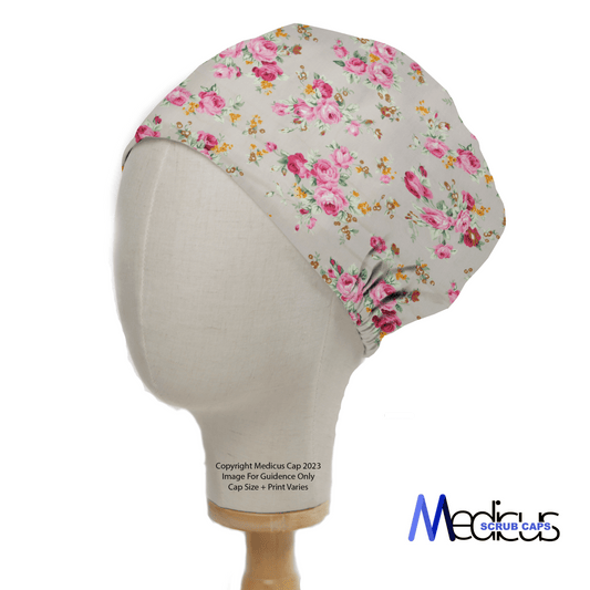 The Medicus Scrub Caps Floral Flower Arrangement Roses Grey Scrub Cap features pink roses on a grey background. Displayed on a mannequin, it’s reusable and designed for healthcare professionals.