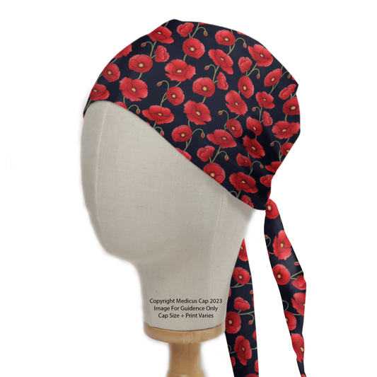 A mannequin head wears the Medicus Scrub Caps Floral Poppies Scrub Cap, showcasing vibrant red poppies. Featuring long ties for personalization, it provides a sustainable option against the plain white background.