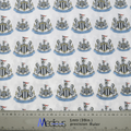 The Football Club Newcastle Scrub Cap by Medicus Scrub Caps features patterned fabric with club crests, black and white shields, lions, and flags. A 1-meter ruler at the bottom symbolizes sustainability and healthcare excellence.