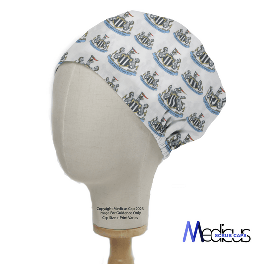 A mannequin wears a Football Club Newcastle Scrub Cap with a crest design on a white background. The cap, branded Medicus Scrub Caps, exemplifies healthcare excellence in sustainable fashion.