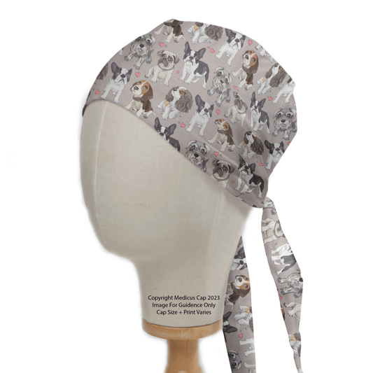 A mannequin head showcases the For The Love Of Dogs Scrub Cap by Medicus Scrub Caps, featuring bulldogs and French bulldogs on a light background. The cap ties at the back for inclusive sizing, ensuring a perfect fit.