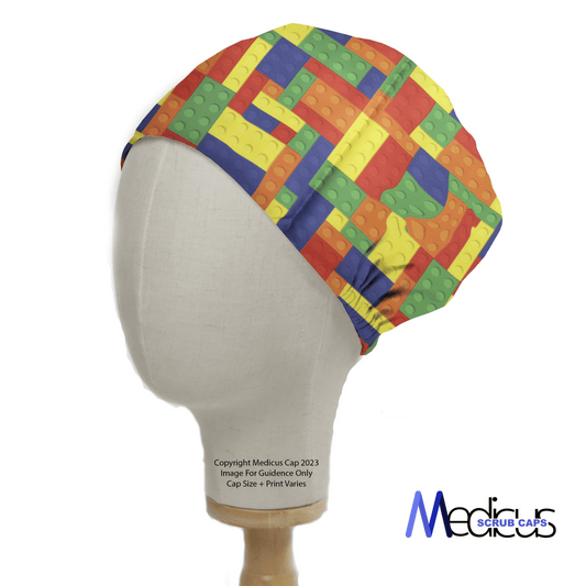 A mannequin head wears the Medicus Scrub Caps Games Lego Tetris Large Scrub Cap, featuring a playful gaming design with red, yellow, blue, and green blocks.