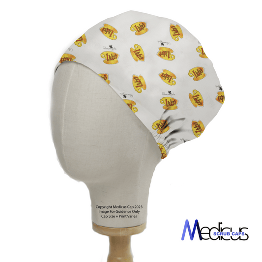 The mannequin wears the Gilmore Girls Lukes Cafe Coffee Scrub Cap by Medicus Scrub Caps, featuring a charming bee and honey jar design on white, reminiscent of Lukes Cafe from Gilmore Girls. The cap fits snugly, showcasing its delightful print.