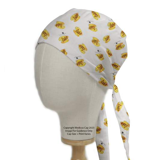 Displayed on a mannequin head, Medicus Scrub Caps Gilmore Girls Lukes Cafe Coffee Scrub Cap features vibrant yellow and orange designs with playful cool text and tiny sunglasses, adding lively flair to your workwear inspired by Gilmore Girls charm.