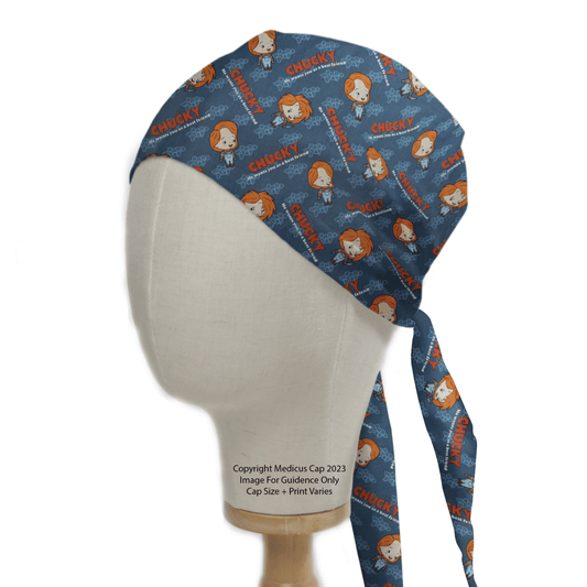 The Halloween Chucky Movie Scrub Cap by Medicus Scrub Caps features cartoon faces with Chucky in red, capturing a horror movie vibe. Displayed on a white mannequin head, it highlights its side and back ties—ideal for fans of reusable scrub caps.