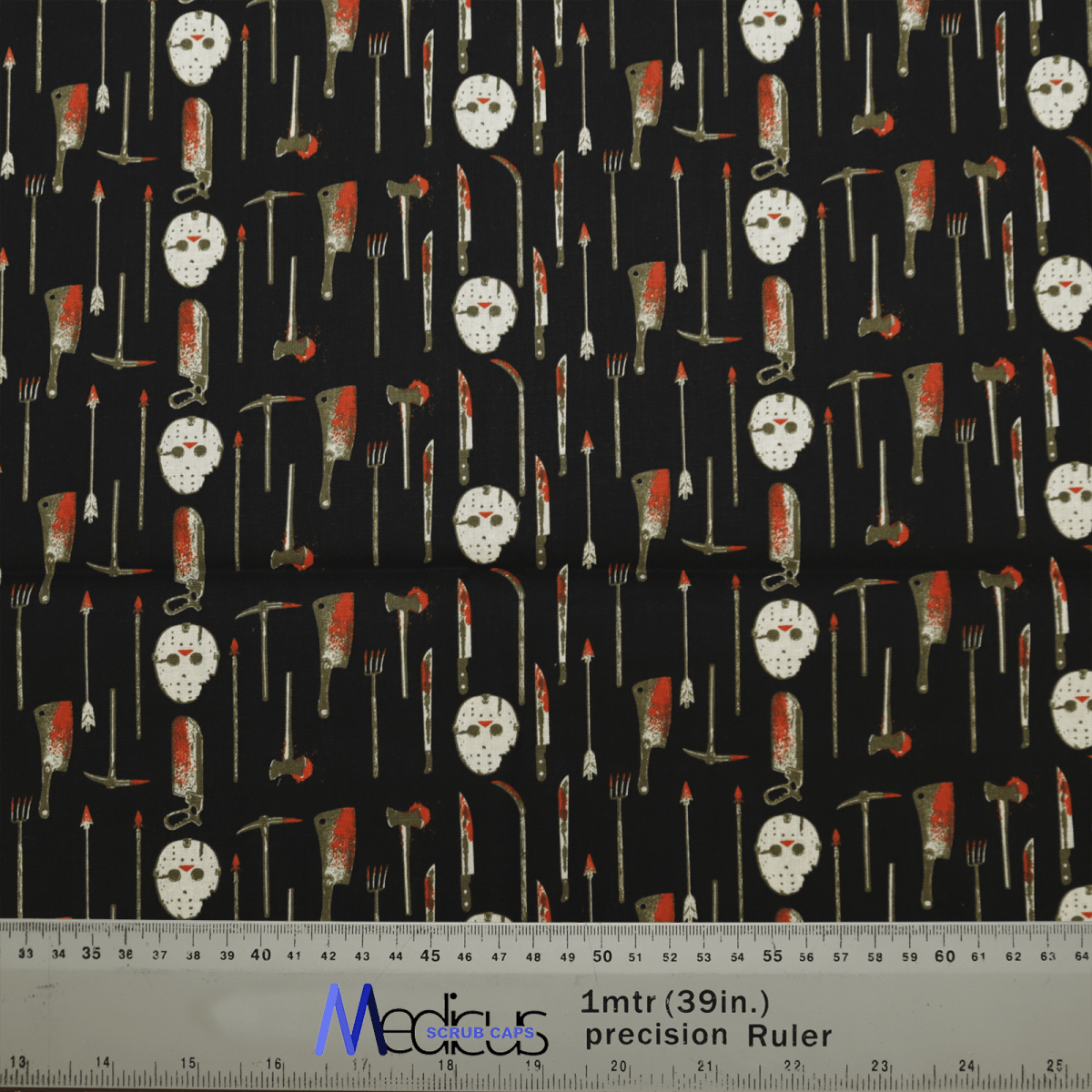 The black fabric of Medicus Scrub Caps Halloween Jason Hockey Mask + Knives design features a spooky pattern of kitchen utensils, bloody cleavers, forks, and knives—ideal for horror fashion lovers. A ruler at the bottom ensures precise cutting measurements.