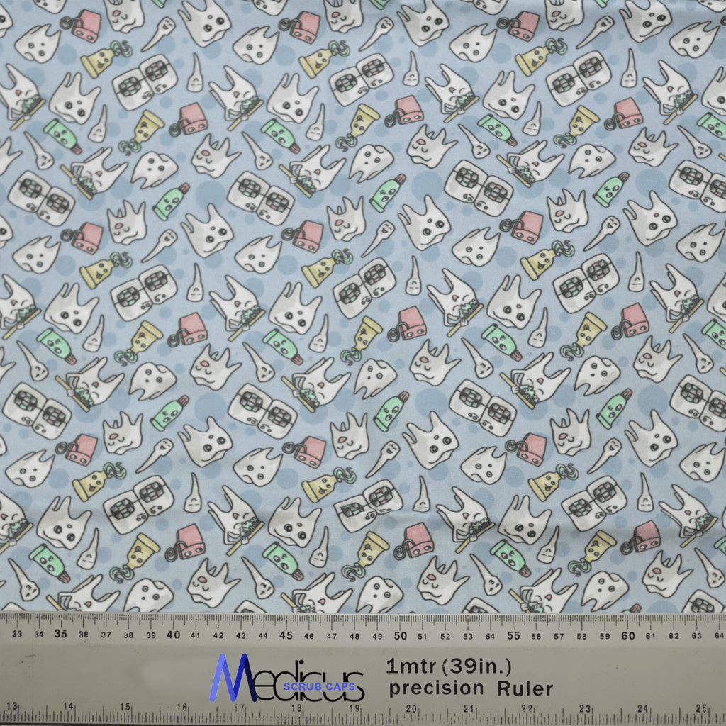The Happy Teeth Braces Scrub Cap by Medicus Scrub Caps boasts a delightful fabric with cartoon teeth, toothbrushes, toothpaste tubes, and dental floss on a light blue background. It also features a ruler on the bottom edge with measurements in inches and centimeters for added dental flair.