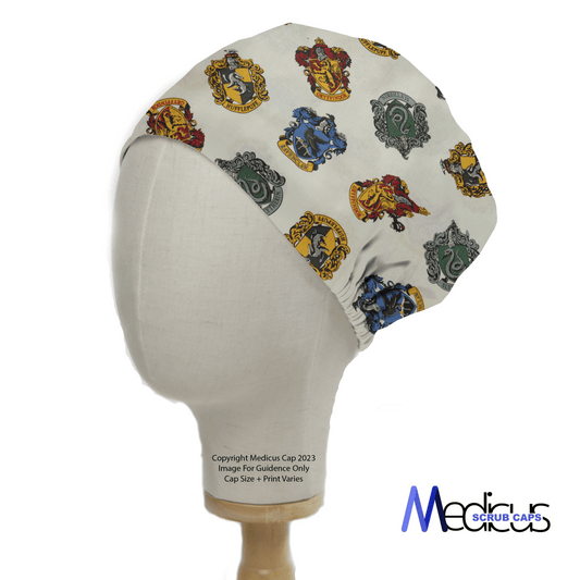 Medicus Scrub Caps presents the Harry Potter Houses Scrub Cap, showcasing prints of the Gryffindor, Hufflepuff, Ravenclaw, and Slytherin crests. Its ideal for healthcare professionals seeking a magical touch to their attire. Displayed on a mannequin with logo and copyright details included.