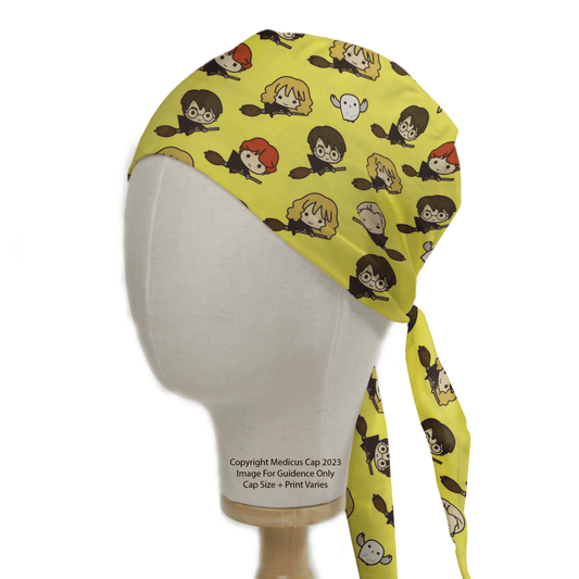 The Harry Potter Nimbus 2000 Scrub Cap by Medicus Scrub Caps features cartoon character faces in a magical pattern on yellow fabric. Displayed on a white mannequin head with long ties, its ready to take flight like the iconic broomstick.