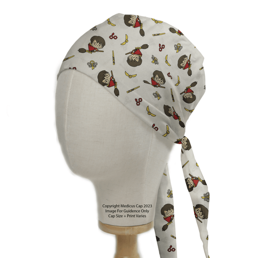 A Medicus Scrub Caps mannequin showcases the sustainable Harry Potter Quidditch Scrub Cap, featuring whimsical designs of a character with round glasses, scissors, and golden snitches. Tying at the back and elegantly displayed on wood, its a must-have for fans.