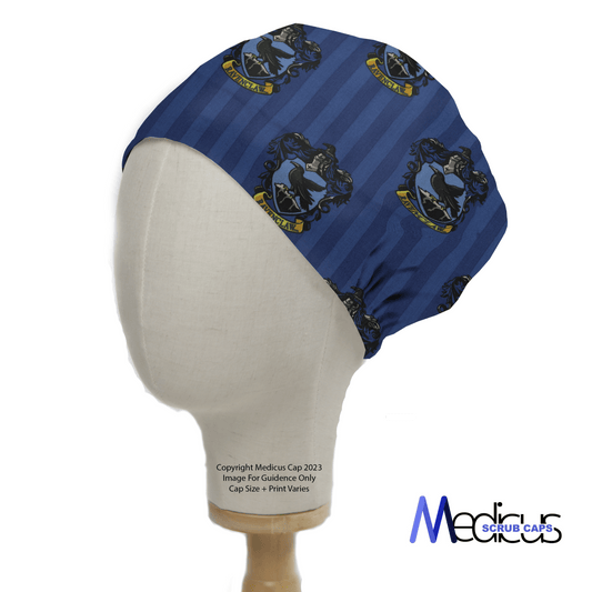 The Harry Potter Ravenclaw Scrub Cap, by Medicus Scrub Caps, features a crest pattern with bird and shield designs evocative of Ravenclaw. Displayed on a mannequin head, it includes an eco-friendly logo and copyright notice in the center.