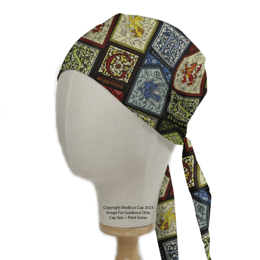 A mannequin head displays the eco-friendly Harry Potter Stain Glass Scrub Cap by Medicus Scrub Caps, featuring a vibrant design with the four Hogwarts house crests—Gryffindor, Slytherin, Ravenclaw, and Hufflepuff—each in its own square.