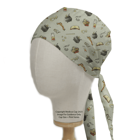 A mannequin head displays a Medicus Scrub Caps Harry Potter Wands Cauldron Scrub Cap featuring potion bottles, books, cauldrons, quills, and scrolls on a pale background. Ideal for Wizarding World fans, it captures the enchanting essence of Harry Potters wands.