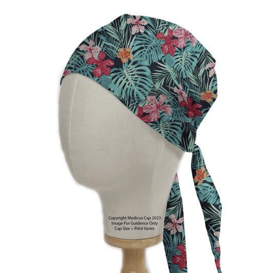 A Medicus Scrub Caps mannequin displays the Hawaiian Shirt Floral Palms Scrub Cap, featuring tropical green palms and vibrant hibiscus flowers in red, pink, and yellow.