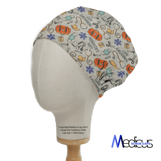 A Healthcare Hero Scrub Cap by Medicus Scrub Caps, featuring ambulances, hearts, stethoscopes, and masks in vibrant blue, red, and yellow on beige fabric, is displayed on a mannequin head as a sustainable choice for medical professionals. The logo is proudly visible.