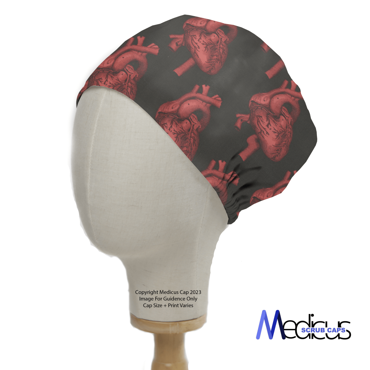 A mannequin head wears the Heart 3D On Black Scrub Cap by Medicus Scrub Caps, featuring red anatomical hearts on black fabric for a bold medical-themed design.