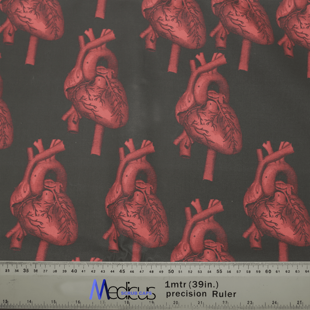 The Heart 3D On Black Scrub Cap by Medicus Scrub Caps features red anatomical hearts on a dark background, with a 1mtr (39in.) ruler for scale.