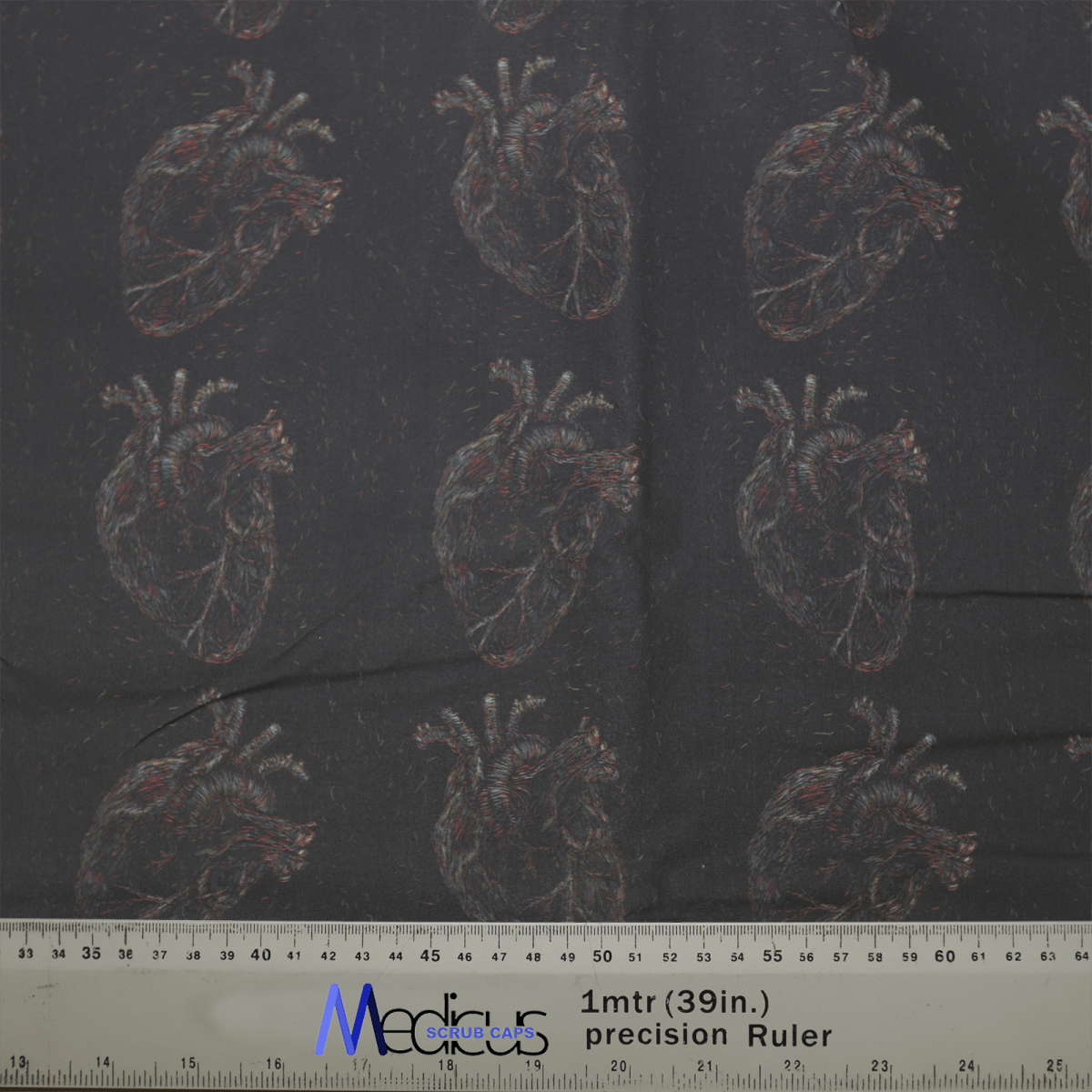 The Heart Faded On Black Scrub Cap by Medicus Scrub Caps features anatomically detailed hearts on dark fabric. A ruler shows it measures about 39 inches.