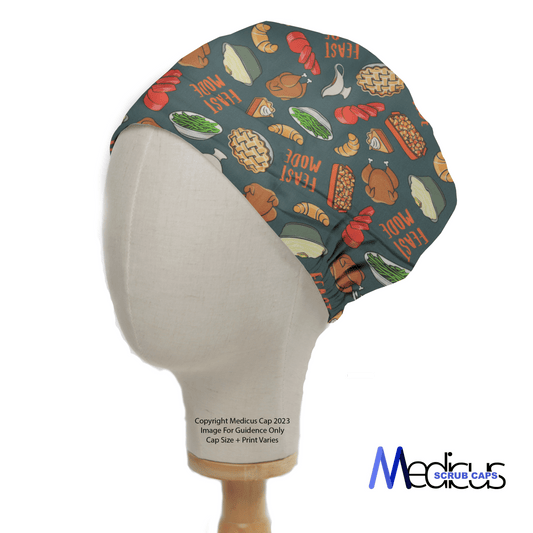 A mannequin head wears the eco-friendly Holidays Thanksgiving Feast Mode scrub cap by Medicus Scrub Caps, featuring vibrant vegetable and bread patterns with the phrase Thanksgiving Feast Mode, set against a white background.