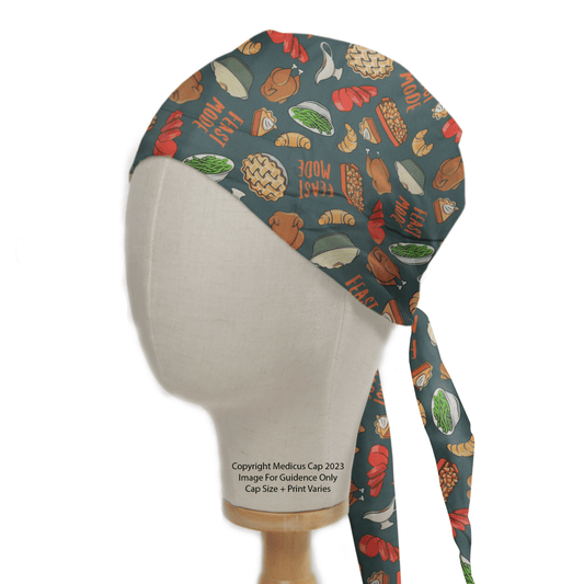 Mannequin sporting the Holidays Thanksgiving Feast Mode Scrub Cap by Medicus Scrub Caps, showcasing an eco-friendly design with foods like burgers, hot dogs, pizza, and vegetables with Thanksgiving Feast Mode across its vibrant pattern and tied at the back.