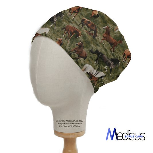 The mannequin head displays the eco-friendly Horses Roaming Free Scrub Cap by Medicus Scrub Caps, featuring brown, white, and black horses in motion on a lush green backdrop. The brand logo is subtly placed at the bottom right corner.