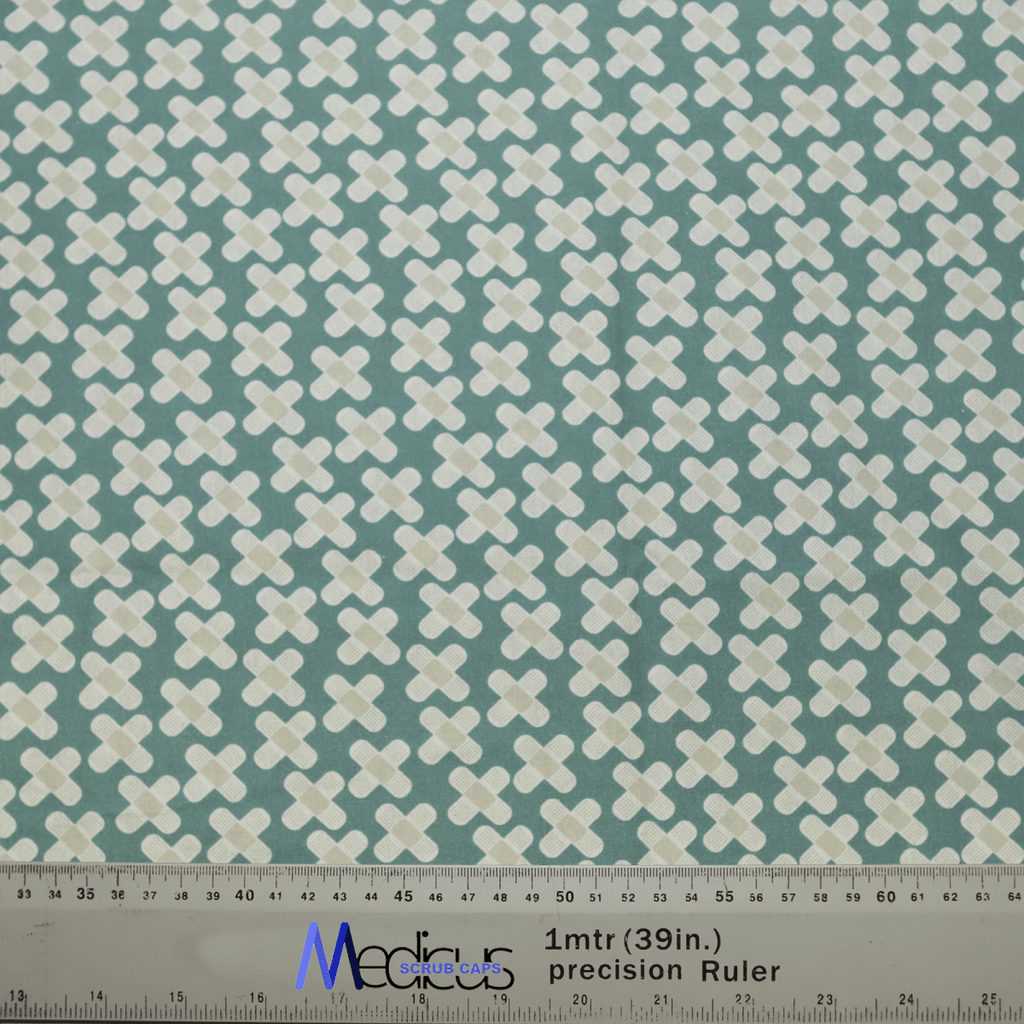 The Hospital Plasters Scrub Cap by Medicus Scrub Caps features a teal background with white plus signs. At the bottom, a measuring ruler labeled 1mtr (39in) precision Ruler in blue and black, ideal for healthcare professionals designing reusable scrub caps.