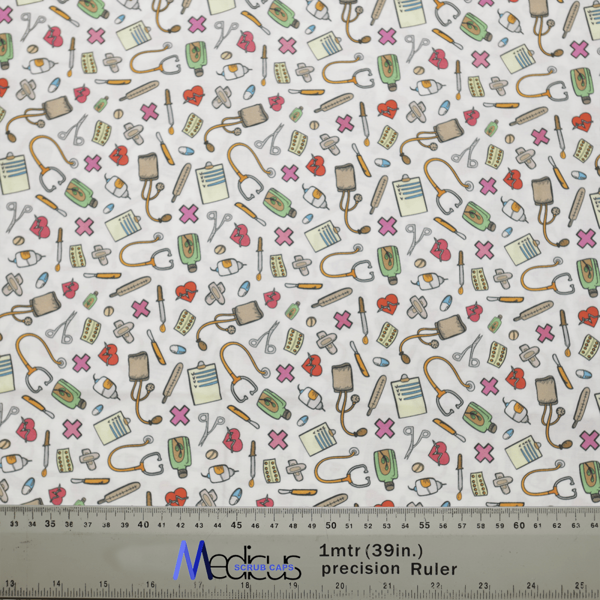 The Hospital Tools On White #2 Scrub Cap by Medicus Scrub Caps features medical-themed illustrations like stethoscopes, syringes, and bandages on a white background with colorful elements. A ruler at the bottom highlights the detail in these sustainable designs.