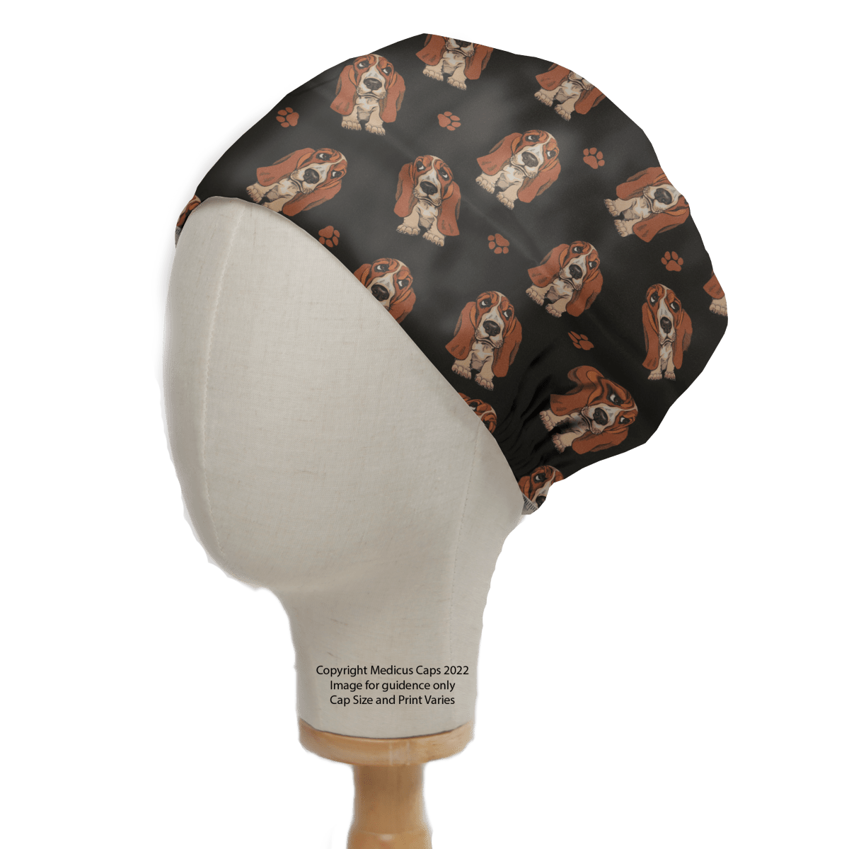 The Hush Puppies Dog Scrub Cap by Medicus Scrub Caps boasts a cute black fabric with Basset Hound dogs and paw prints, making it an ideal, playful, and reusable accessory for dog lovers.