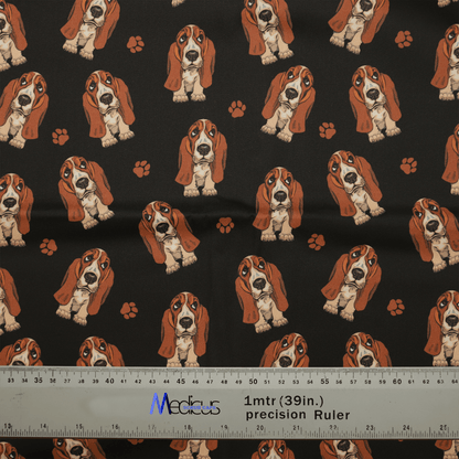 The Hush Puppies Dog Scrub Cap by Medicus Scrub Caps features a playful pattern of cartoon basset hounds and paw prints on black, perfect for crafting. A ruler showing 1 meter (39 inches) at the bottom ensures precise cuts.