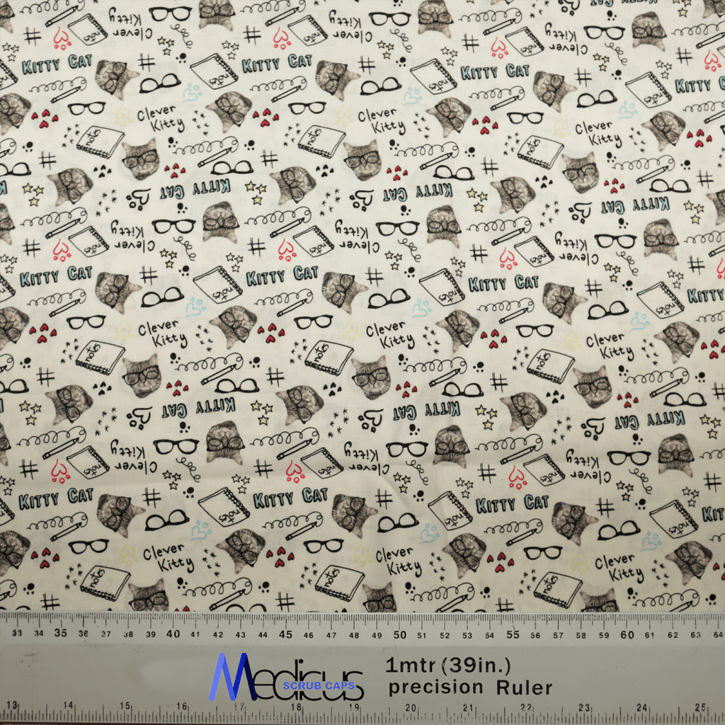 The Kitty Cat Homework Scrub Cap by Medicus Scrub Caps features cat sketches with books and glasses, playful phrases, hearts, and paw prints. Ideal for whimsical healthcare professionals, it measures 1 meter (39 inches) as shown by the ruler below.