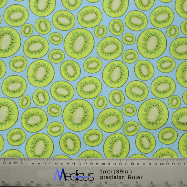 Introducing the Kiwi Scrub Cap by Medicus Scrub Caps, featuring a vibrant sliced kiwifruit design on light blue fabric. Its Medias ChaChaCAS ruler ensures a perfect fit, combining style and sustainability for your wardrobe.