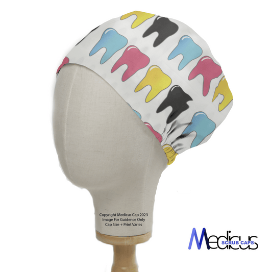 A mannequin head displays the Medicus Scrub Caps Large Colourful Teeth Scrub Cap, featuring vibrant blue, yellow, pink, and black tooth patterns. The brand logo is on the lower right.