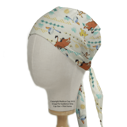 A Medicus Scrub Caps mannequin head models the Lion King Timone And Pumba Scrub Cap, adorned with playful animal illustrations including a fox and birds. It ties at the back for a comfortable fit, perched on a plain stand against a light background.