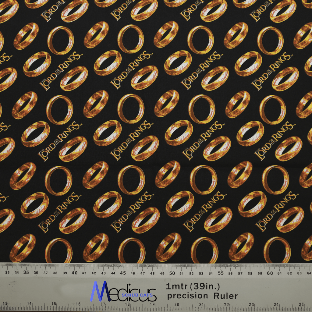 Medicus Scrub Caps offers the Lord Of The Rings - Golden Rings Scrub Cap, featuring sustainable fabric with golden rings and Lord of the Rings on a black background. Perfect for crafting uniquely detailed scrub caps with a precision ruler at the bottom.