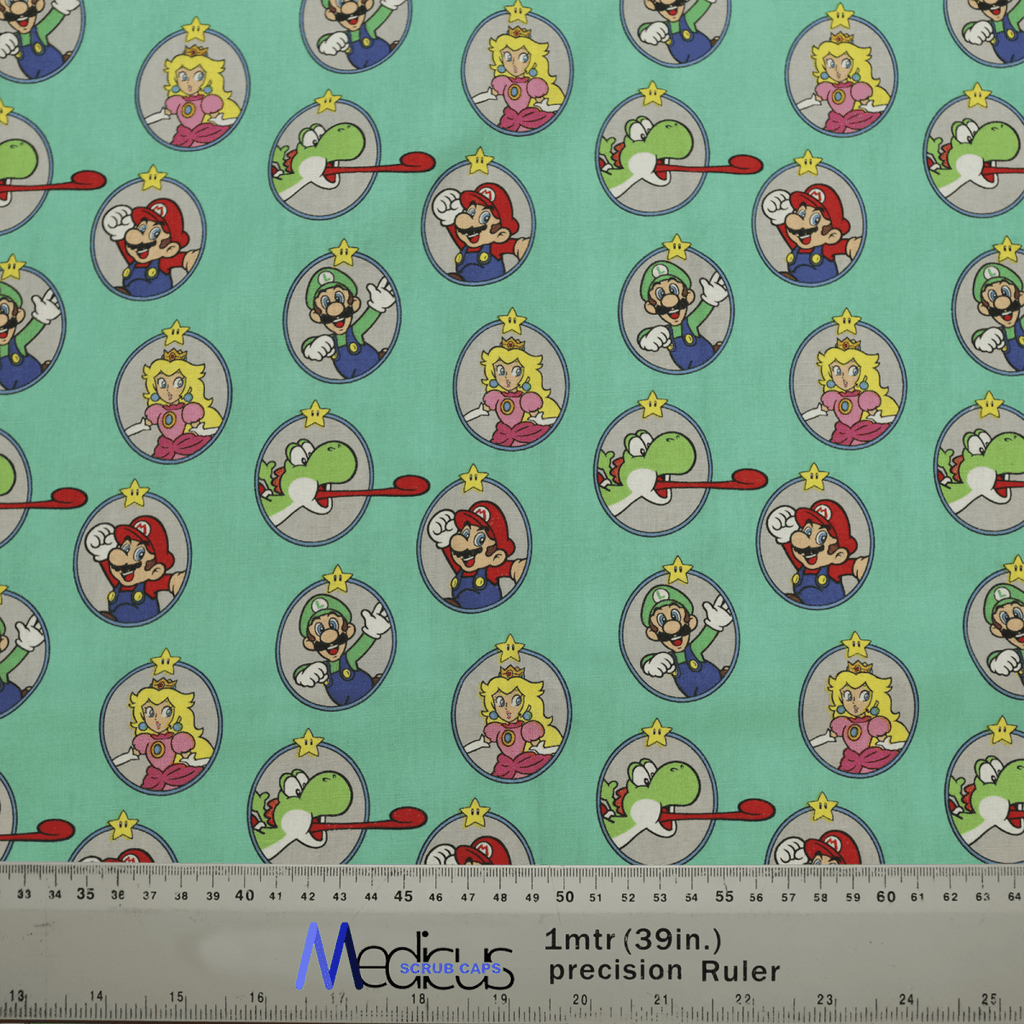 Medicus Scrub Caps Mario Yoshi Toad Green scrub cap fabric features cartoon characters in circles with red, green, pink, and yellow outfits on a teal background. Ideal for video game-themed healthcare attire. A Precision Ruler at the bottom shows a scale of 1 meter (39 inches).