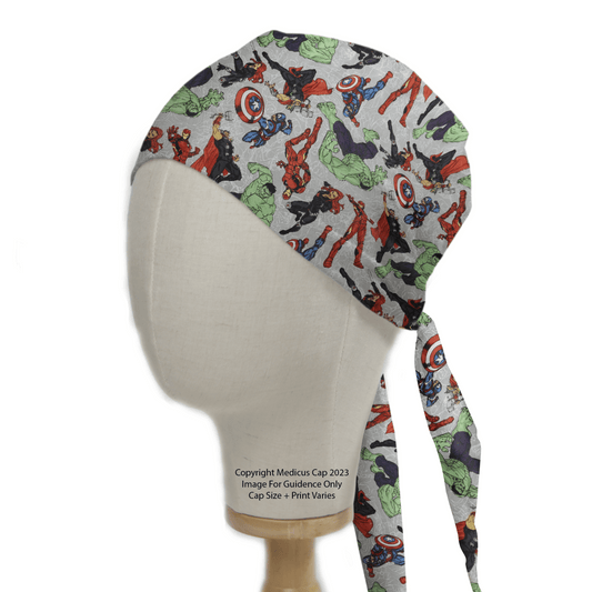 A mannequin head showcases the Marvel Avengers #2 - Fighting Pose On Grey Scrub Cap by Medicus Scrub Caps, teeming with vibrant superhero illustrations in red, green, and blue. Ideal for healthcare professionals wanting a heroic look, it features ties elegantly draping down the back.