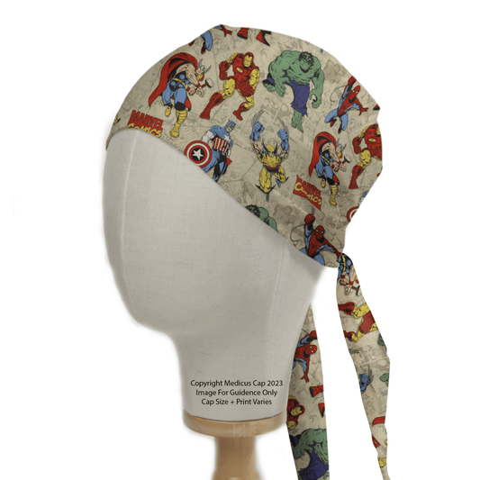 Displayed on a mannequin head is the eco-friendly Marvel Comics #5 Scrub Cap by Medicus Scrub Caps. It features vibrant superheroes in action, with capes, shields, and green skin accents. The cap ties neatly at the back against a plain white background.